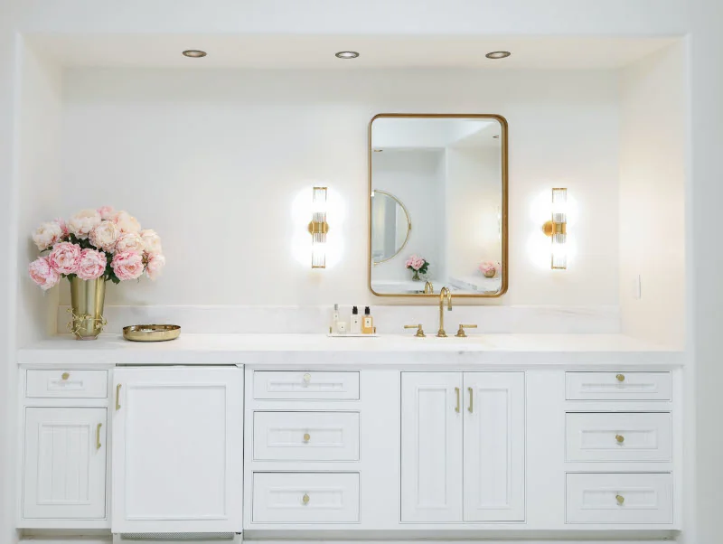 Master bathroom remodel in San Diego featuring white cabinetry, marble countertops, gold fixtures, and a clean, modern design.
