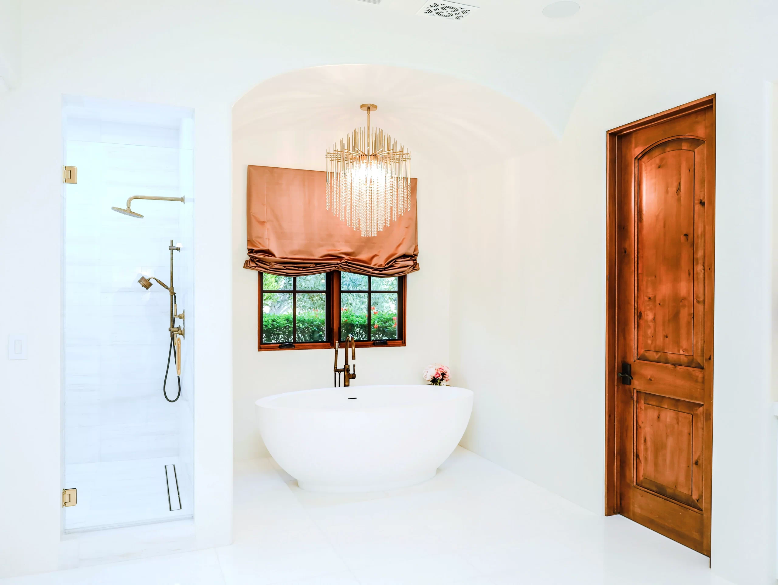 Master bathroom renovation in San Diego featuring a deep freestanding tub, walk-in shower, and gold fixtures.